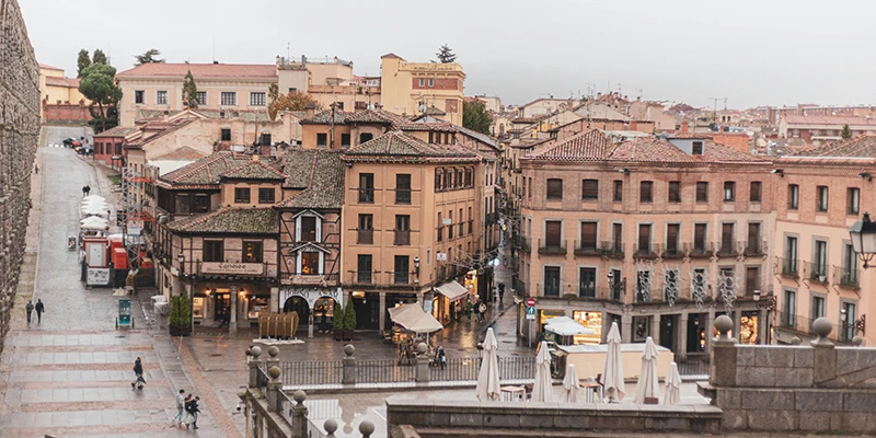 Calle Juan Bravo, the main pedestrian street of Segovia's old town lined with historic buildings